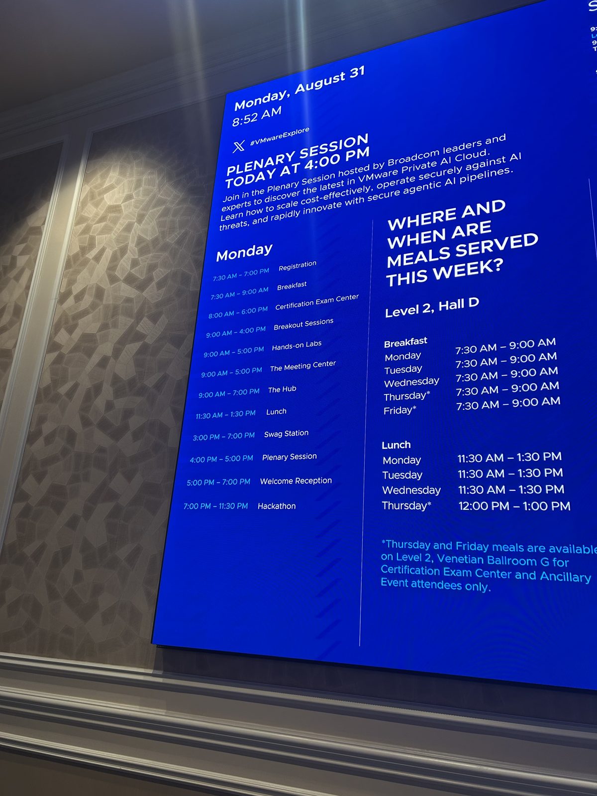 Digital signage listing the Monday, August 31 schedule for VMware Explore 2026, timestamped 8:52 AM