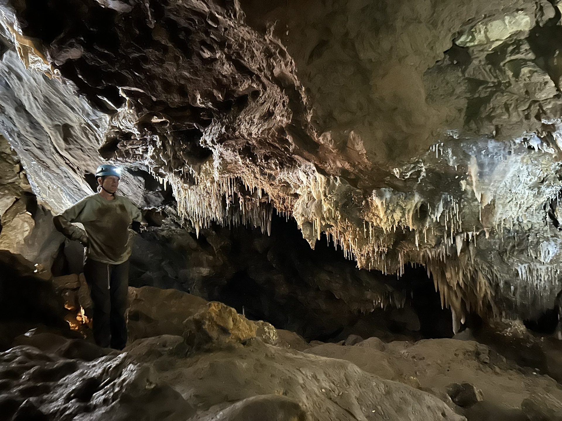 Person lecturing inside the cave with incredible stalactites