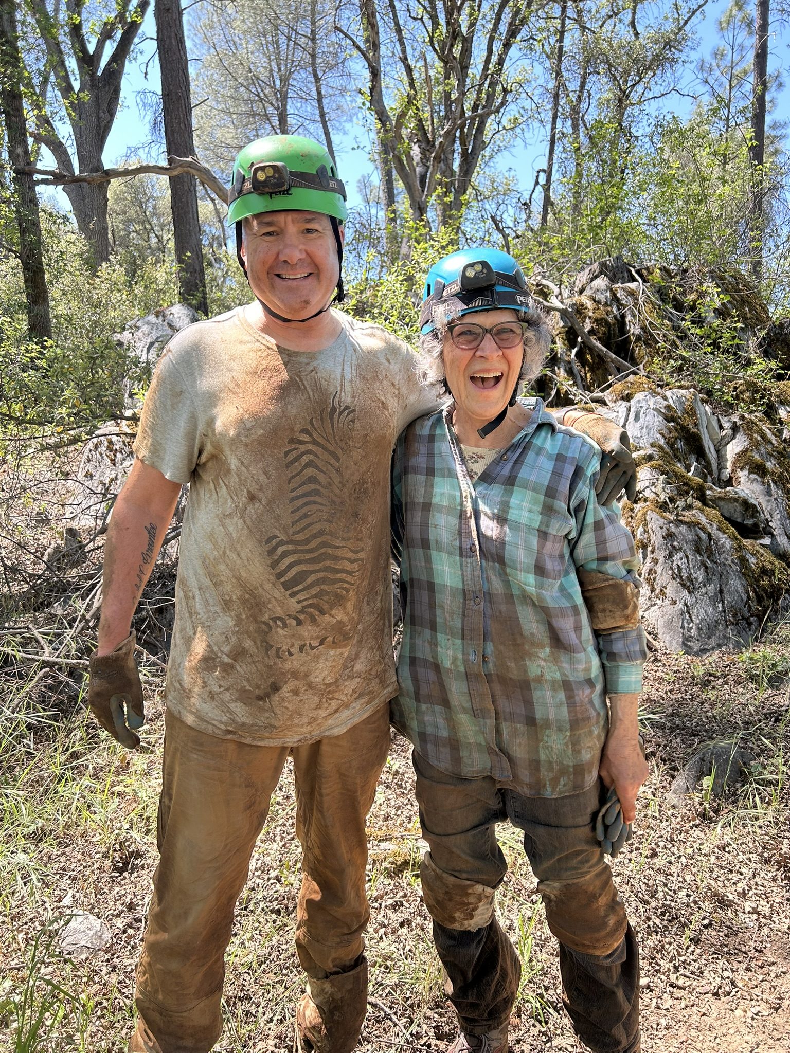 Robert and companion post-tour covered in mud smiling