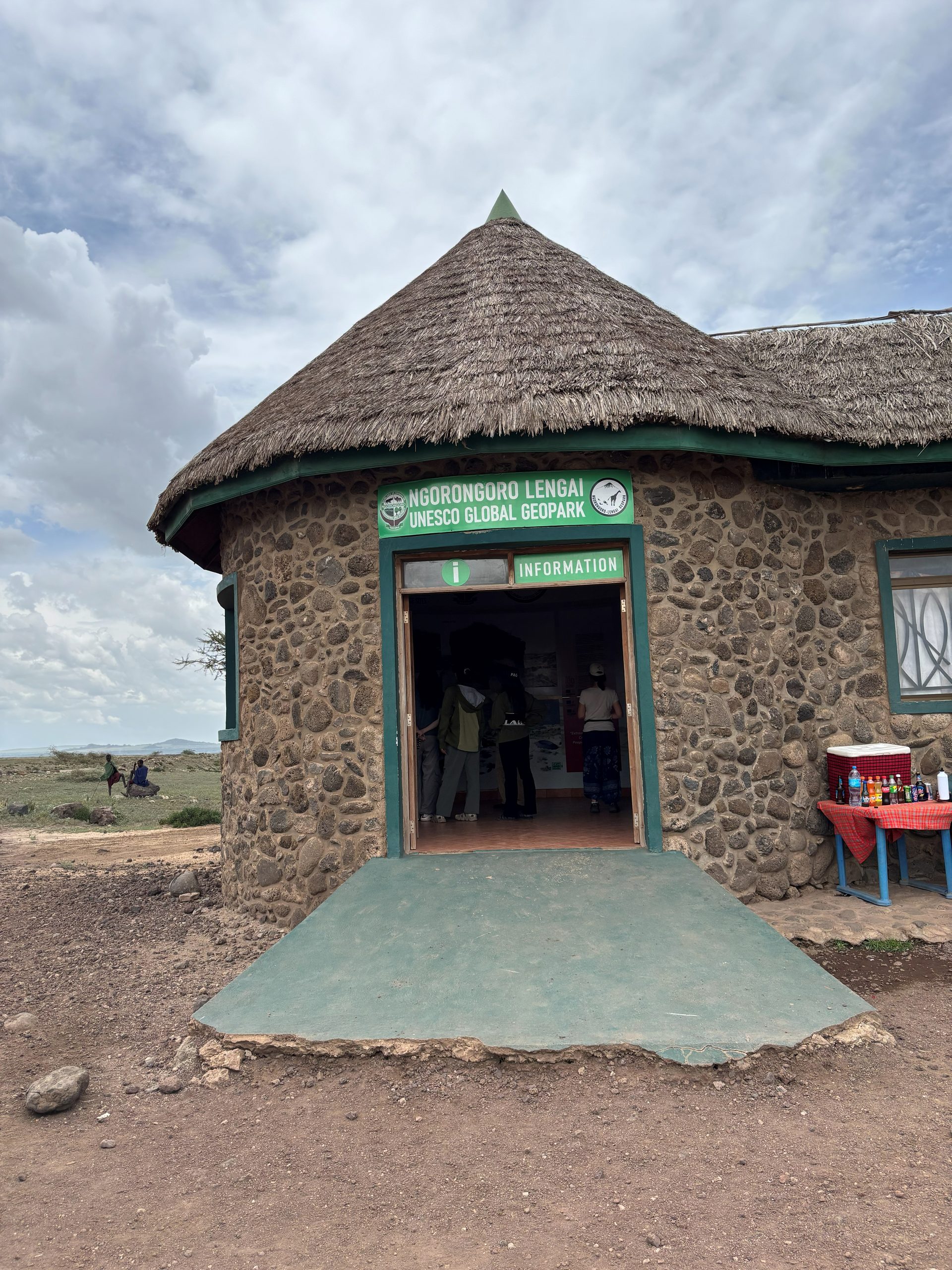 Ngorongoro Lengai UNESCO Global Geopark information hut — round stone building with thatched roof