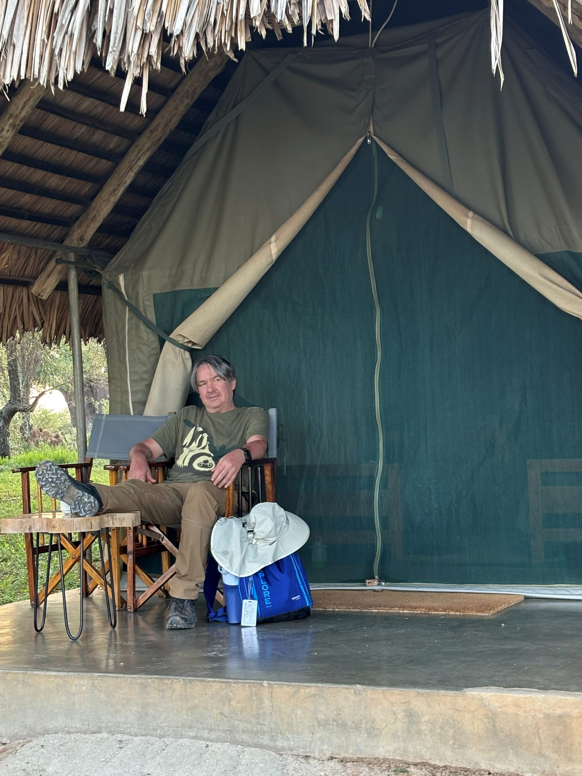 Robert relaxing in a director's chair on the tent porch at Tarangire Safari Lodge